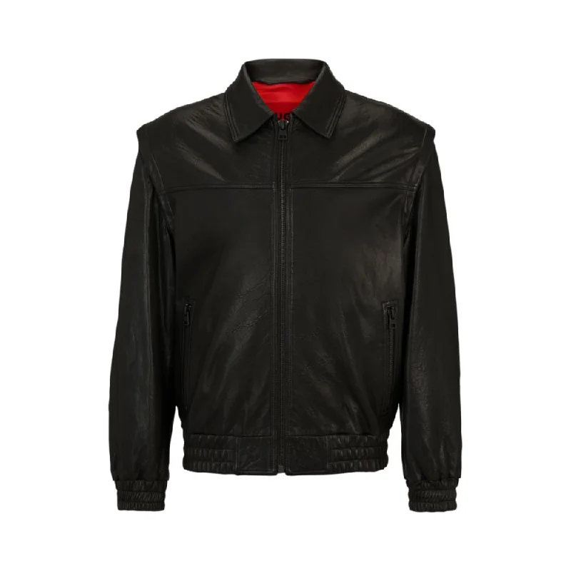 Leather jacket with detachable sleeves and stud artwork